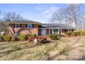 Charming two-story brick home boasting manicured landscaping and a well-maintained front lawn at 220 Augusta Dr, Statesville, NC 28625