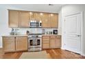 Updated kitchen with stainless steel appliances, granite counters, wooden cabinetry, and hardwood floors at 2203 Whitford Ln, Charlotte, NC 28210