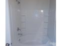All-white bathroom featuring a tub and shower combo at 2440 Mint Thistle Ct, Charlotte, NC 28269