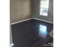 Spacious room with hardwood flooring and a large window for natural light at 2440 Mint Thistle Ct, Charlotte, NC 28269