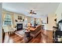 Cozy living room featuring hardwood floors, fireplace, and large windows providing natural light at 2630 Filson Ct, Charlotte, NC 28214