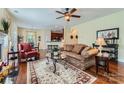 Inviting living room boasts hardwood floors, a ceiling fan, and seamless flow to the kitchen area at 2630 Filson Ct, Charlotte, NC 28214
