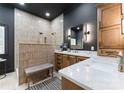 Spa bathroom features a neutral tile shower, double sink vanity with quartz countertops at 2818 Levinfield Ct, Lincolnton, NC 28092