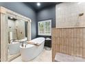 Beautiful bathroom features a soaking tub with a large decorative mirror and tiled walk-in shower at 2818 Levinfield Ct, Lincolnton, NC 28092