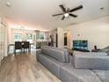 Open-concept living space with hardwood floors, ceiling fan, and stainless steel kitchen appliances at 285 Hannah Ave, Salisbury, NC 28147