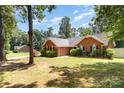 Beautiful brick home with mature trees and a well-kept lawn at 2916 Northwood Dr, Monroe, NC 28110