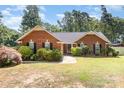 Charming brick home with a well-manicured lawn and lush landscaping at 2916 Northwood Dr, Monroe, NC 28110