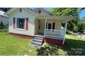 A charming home with a cozy porch and red accents at 300 Gurley St, Kannapolis, NC 28081