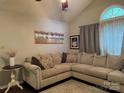 Comfortable living room features large sectional sofa, soft rug, and vaulted ceiling at 328 Glenridge Ct, Indian Trail, NC 28079