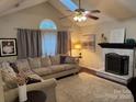 Cozy living room with fireplace, vaulted ceiling, and lots of natural light at 328 Glenridge Ct, Indian Trail, NC 28079