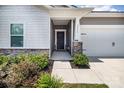 Covered entryway with landscaped yard and a black front door at 3313 Plum Dr, Monroe, NC 28110