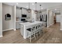 Modern kitchen with gray cabinetry, stainless appliances and an island with bar seating at 3313 Plum Dr, Monroe, NC 28110