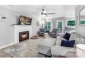 Inviting living area with a fireplace, comfortable seating, and seamless access to the outdoor patio at 3705 Chesapeake Pl, Waxhaw, NC 28173