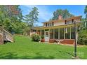 The outdoor space features a screened-in porch, steps, manicured lawn, and mature landscaping at 408 E Blume St, Landis, NC 28088