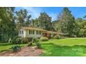 Exterior of home featuring a well maintained lawn, mature trees, and charming curb appeal on a sunny day at 408 E Blume St, Landis, NC 28088