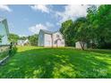 Expansive backyard with lush green lawn and mature trees, perfect for outdoor activities at 4230 Chatterleigh Dr, Monroe, NC 28110