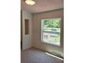 Bright bedroom with a large window showcasing the natural landscaping and sunlight at 44112 Harper Hearne Rd, New London, NC 28127
