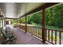Inviting covered front porch with wood floors, railings, and comfortable seating, overlooking a well-maintained lawn at 485 Johnson St, China Grove, NC 28023
