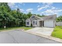 Exterior shot showcases the home's manicured lawn, driveway, and inviting curb appeal at 4894 Prowess Ln, Indian Land, SC 29707