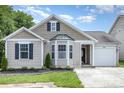 Charming single-Gathering home featuring manicured lawn, neutral siding, and attached one-car garage at 4894 Prowess Ln, Indian Land, SC 29707