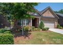 Beautiful brick home with a well-kept front yard, mature trees, and a charming covered entrance at 5268 Courtyard Ln, Belmont, NC 28012