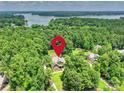 Aerial view of a secluded home nestled in lush greenery, near a scenic lake at 631 May Green Dr, Clover, SC 29710