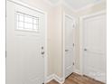 Bright foyer featuring a wooden floor, white doors, and neutral wall paint, creating a clean and welcoming space at 6430 Matlea Ct, Charlotte, NC 28215