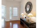 Bright entryway featuring hardwood floors, a decorative mirror, and a glass paneled front door at 7057 Shenandoah Dr, Fort Mill, SC 29707