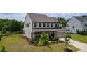 Beautiful two-story home with a well-maintained lawn, fenced yard, and lovely landscaping at 7058 Cloer Ct, Charlotte, NC 28214
