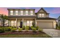 Charming two-story home featuring a manicured front yard and attached two-car garage at 7058 Cloer Ct, Charlotte, NC 28214