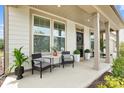 Inviting front porch with seating area, perfect for relaxing and enjoying the outdoors at 7058 Cloer Ct, Charlotte, NC 28214