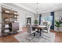 Elegant dining area featuring a modern chandelier, stylish furnishings, and an open layout, perfect for entertaining at 7355 Drury Ln, Denver, NC 28037