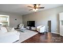 Bright living room with wood floors, plush seating, and a modern glass coffee table at 9530 Drains Bay Ct, Charlotte, NC 28214