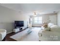 Inviting living room with a large TV, contemporary furniture, and neutral decor at 9530 Drains Bay Ct, Charlotte, NC 28214