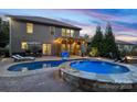 Backyard features a pool, hot tub, patio and outdoor kitchen with a grill and bar at 1026 Arges River Dr, Fort Mill, SC 29715