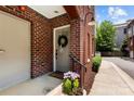 Charming front door with a wreath and flower pots create a welcoming entrance at 106 N Laurel Ave # 118, Charlotte, NC 28207