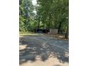 A wooden shed with an open front provides extra storage and parking for vehicles at 11204 Williams Rd, Mint Hill, NC 28227