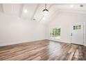 Bright living room with vaulted ceilings, hardwood floors, a large window, and an entry door at 1189 Quiet Acres Rd, Rock Hill, SC 29732
