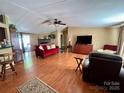 Bright living room featuring hardwood floors, a cozy fireplace, and neutral paint at 1341 Pleasant Hill Church Rd, Wadesboro, NC 28170