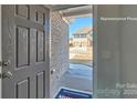 View of an open doorway, brick exterior, and doormat in a well-lit foyer at 159 Apple Orchard Ct, Statesville, NC 28677
