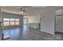 Open-concept living room with wood-style flooring, lots of natural light, and seamless flow to the kitchen at 159 Apple Orchard Ct, Statesville, NC 28677
