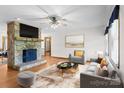 Cozy living room with a striking stone fireplace, neutral decor, and ample natural light at 160 Walking Horse Run, Stanley, NC 28164