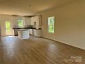 Open-concept kitchen featuring white cabinets, an island, and stainless steel appliances at 1727 E Cloaninger Ave, Statesville, NC 28625