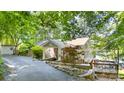 Charming exterior view showcasing architectural details and beautiful landscaping to the lake front at 208 Island View Rd, Mount Holly, NC 28120