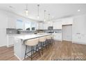 Bright, modern kitchen featuring a large island with bar seating, stainless appliances, and stylish pendant lights at 233 Wheatfield Dr # 102P, Statesville, NC 28677