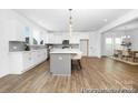 Modern kitchen with a large island and barstool seating, stainless appliances, and hardwood flooring at 233 Wheatfield Dr # 102P, Statesville, NC 28677