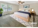 Comfortable primary bedroom with ample natural light, a ceiling fan, and a decorative area rug at 27 Quayside Ct, Clover, SC 29710