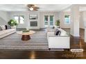 Bright living room with modern furnishings, fireplace, and doors to the exterior, seamlessly blending style and comfort at 27 Quayside Ct, Clover, SC 29710