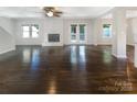 Spacious living room with beautiful hardwood floors, fireplace, windows, and patio door, creating a bright and airy space at 27 Quayside Ct, Clover, SC 29710