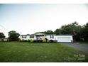 Charming single story home with a sprawling green lawn and a gravel driveway at 34107 Watson Rd, Albemarle, NC 28001